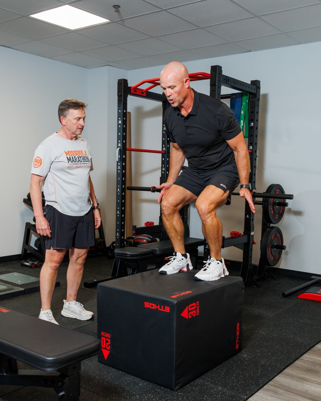 A coach guiding a box jump